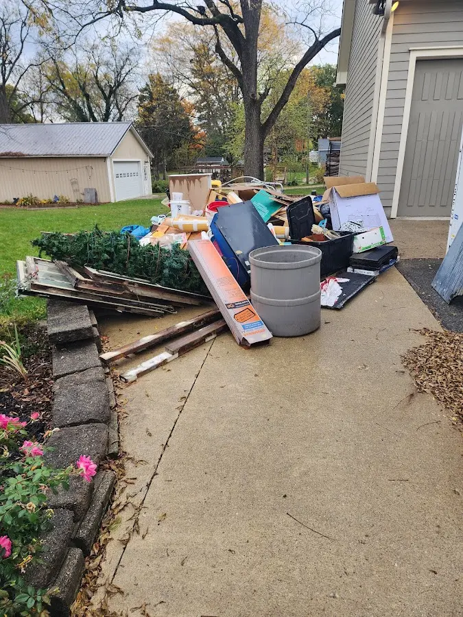 Dumpster being loaded with debris for 10 Yard Dumpster Rental in Fayette